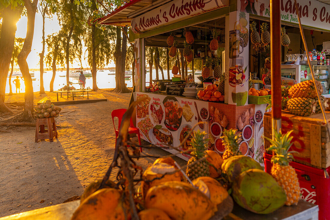 View of coconut and fruit stall in Grand Bay at golden hour, Mauritius, Indian Ocean, Africa