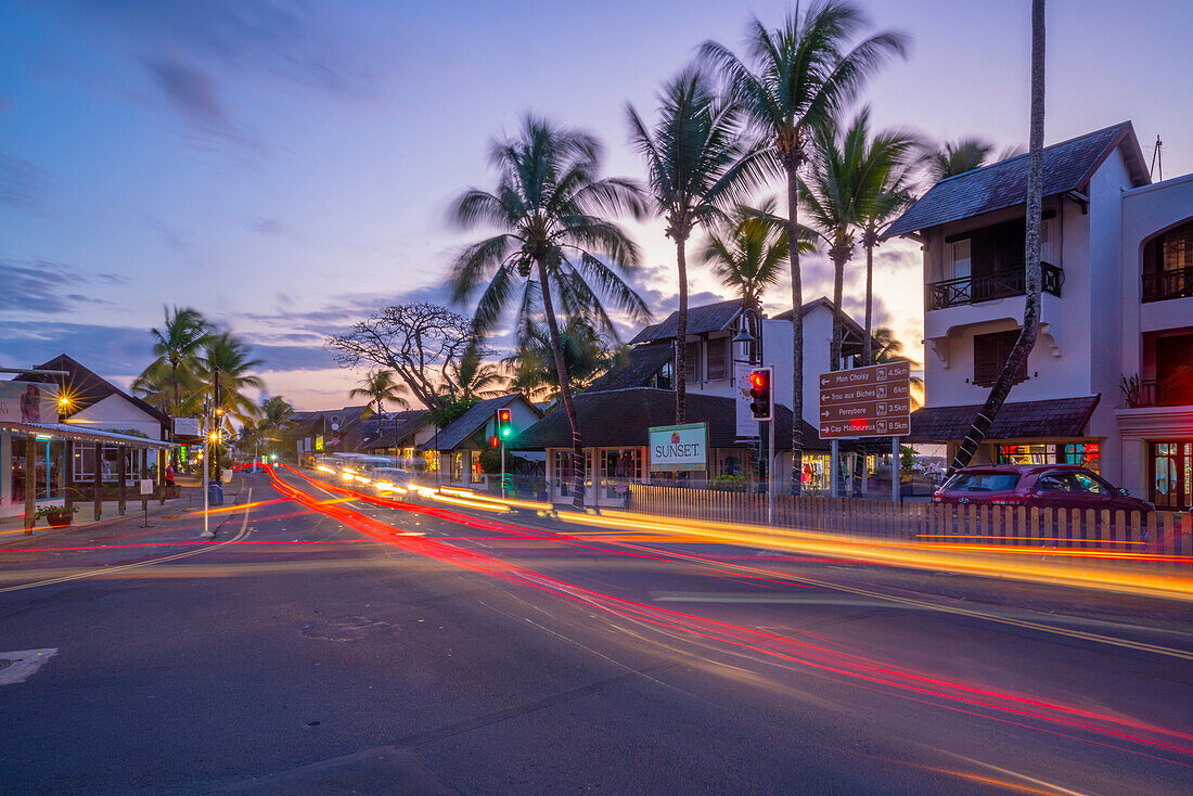 View of palm trees and boutique shops in Grand Bay at dusk, Mauritius, Indian Ocean, Africa