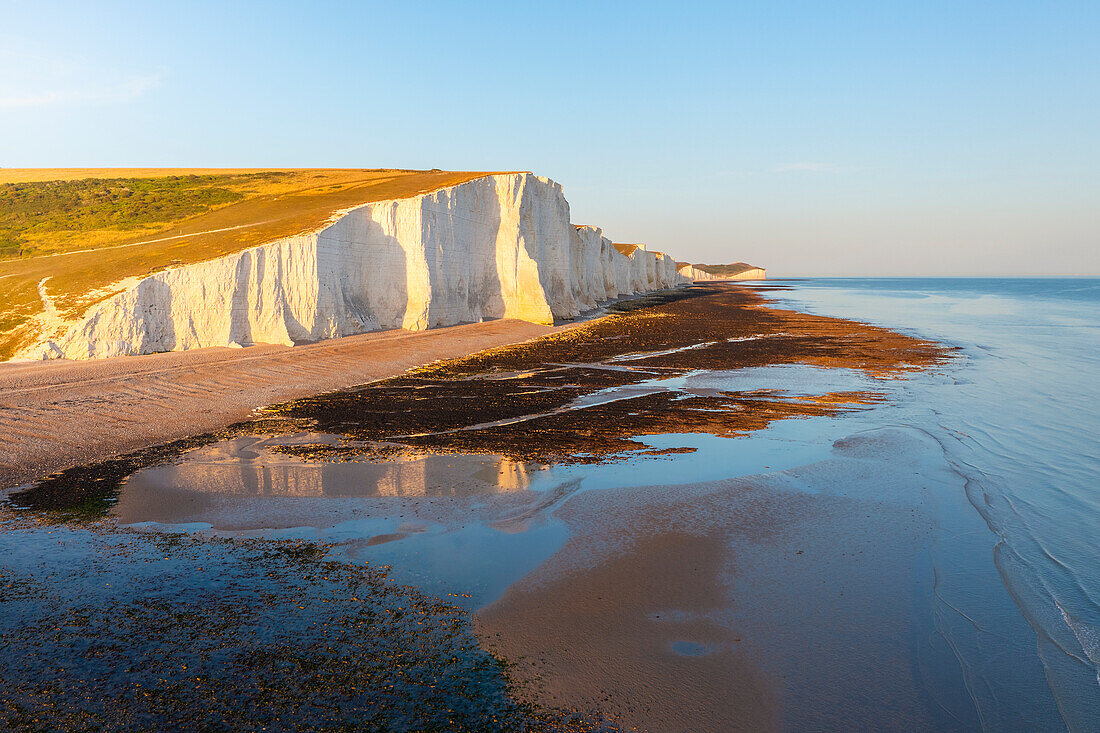 Aerial view of Seven Sisters chalk cliffs at sunset, South Downs National Park, East Sussex, England, United Kingdom, Europe