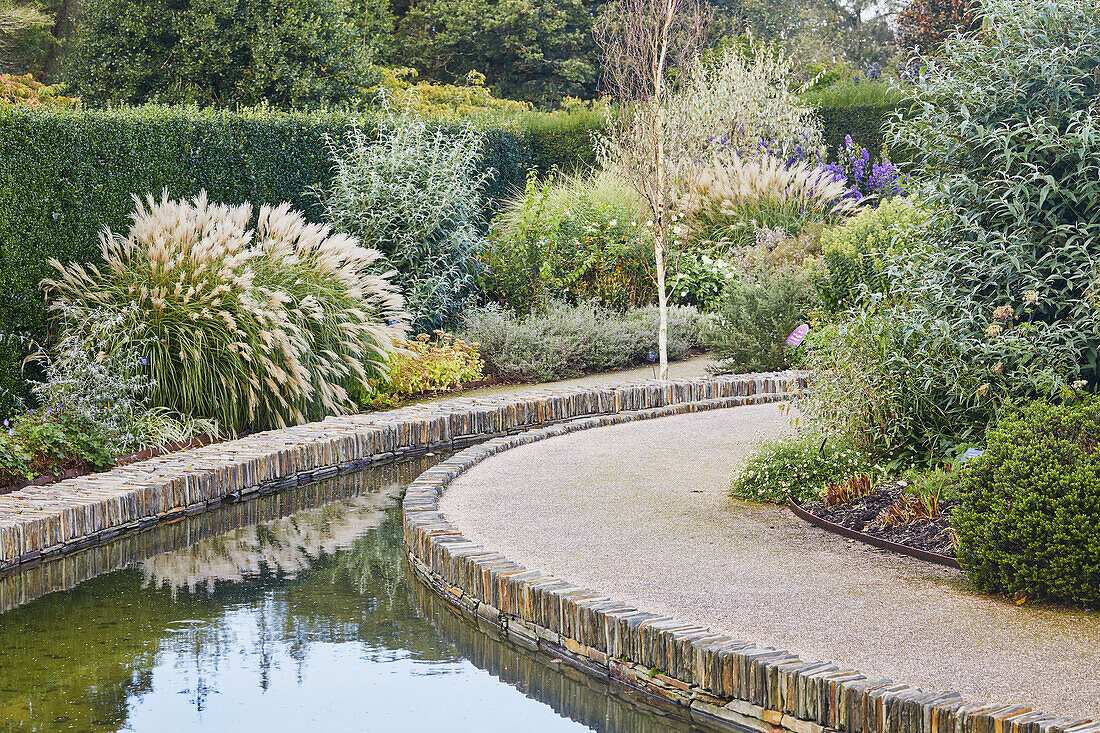 A formal garden scene, with water channel, Devon, England, United Kingdom, Europe