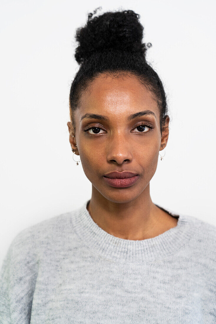 Front view portrait of woman looking at the camera with white background