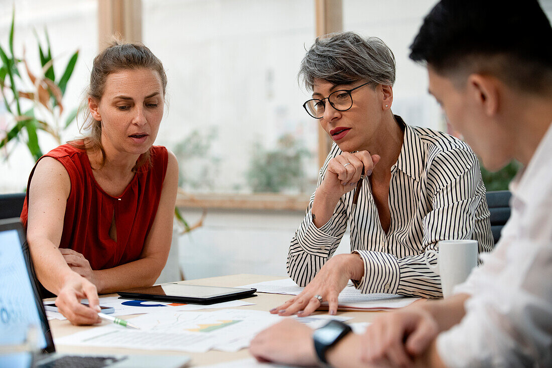 Businesswoman discussing project with coworkers