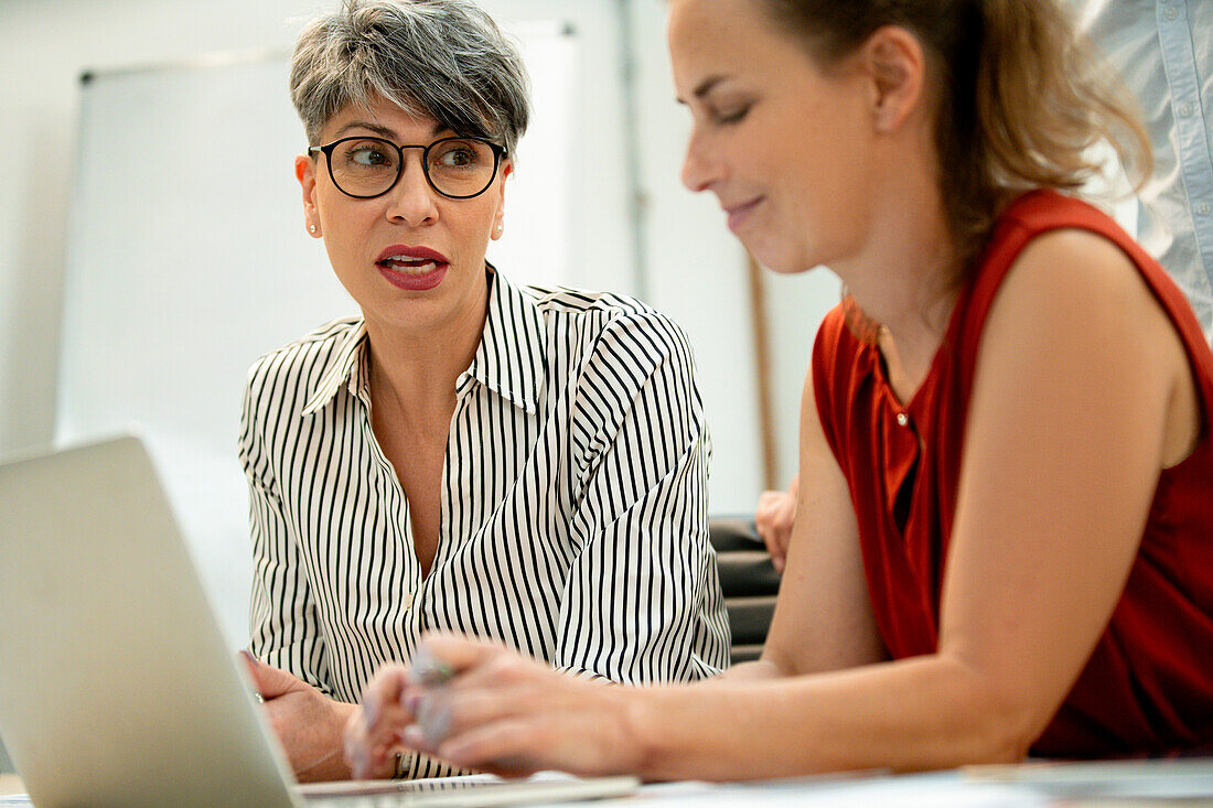 Businesswomen working on laptop at office