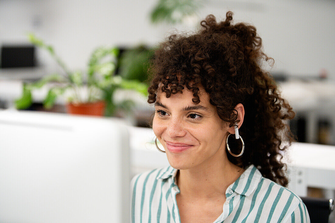 Businesswoman smiling while working on computer