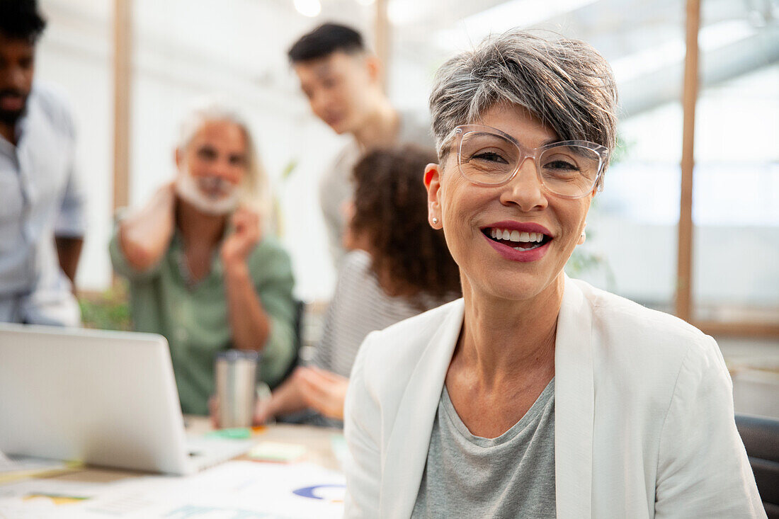 Female agency manager looking at the camera during meeting