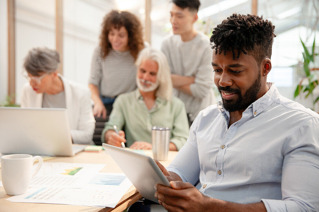 Businessman working with digital tablet during meeting