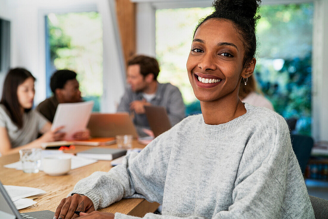 Female accountant looking at the camera while working at desk