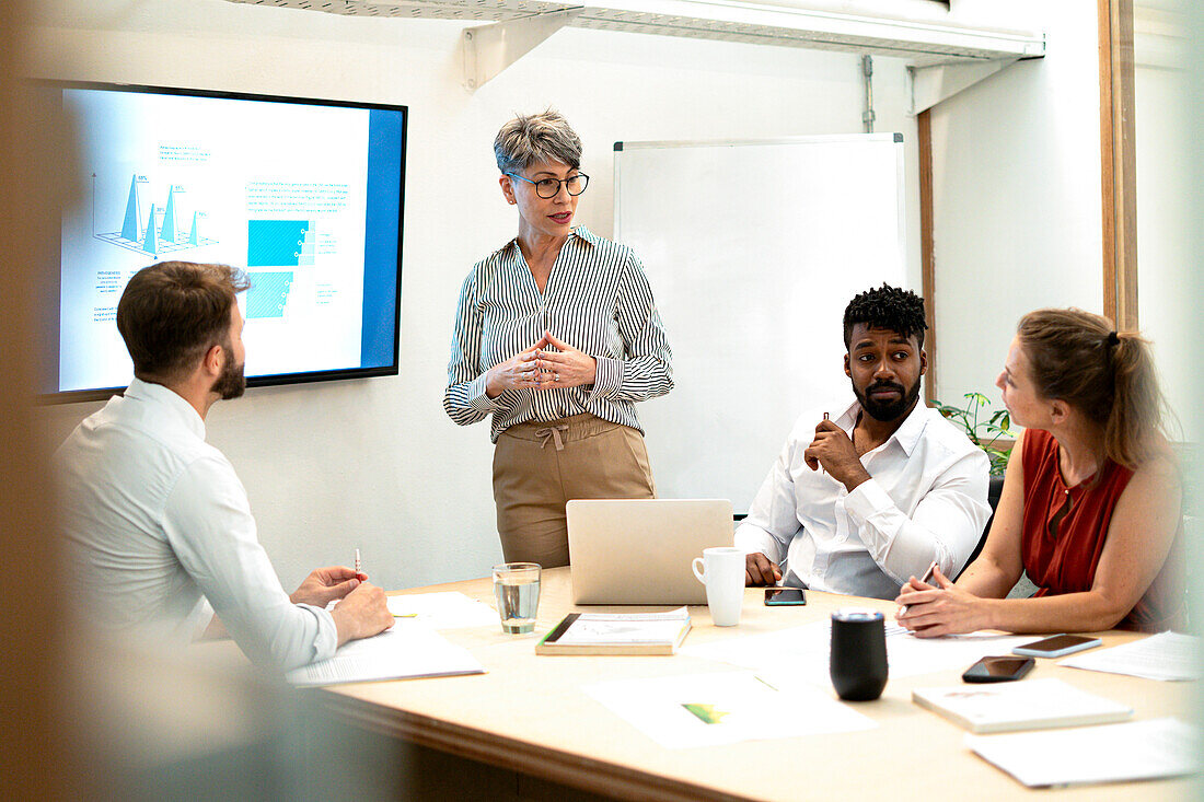 Businesswomen doing a presentation to colleagues at conference room