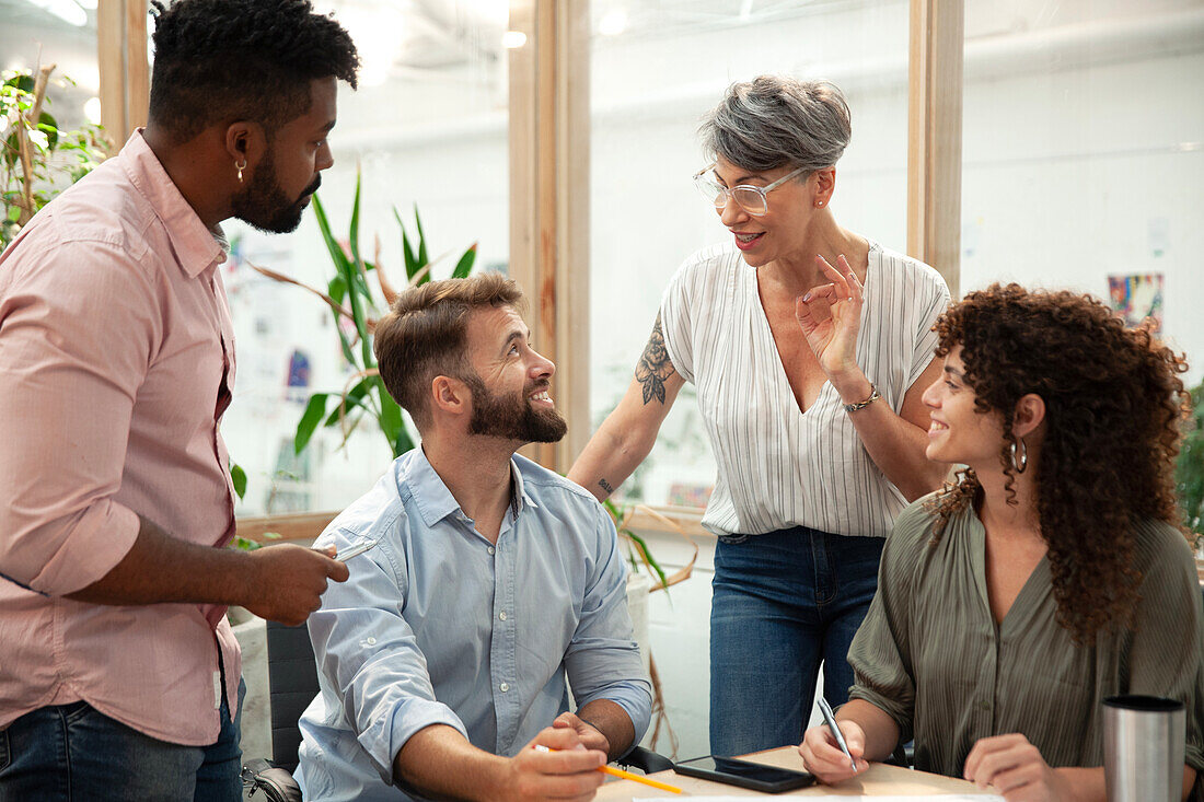 Group of coworkers brainstorming during meeting at office