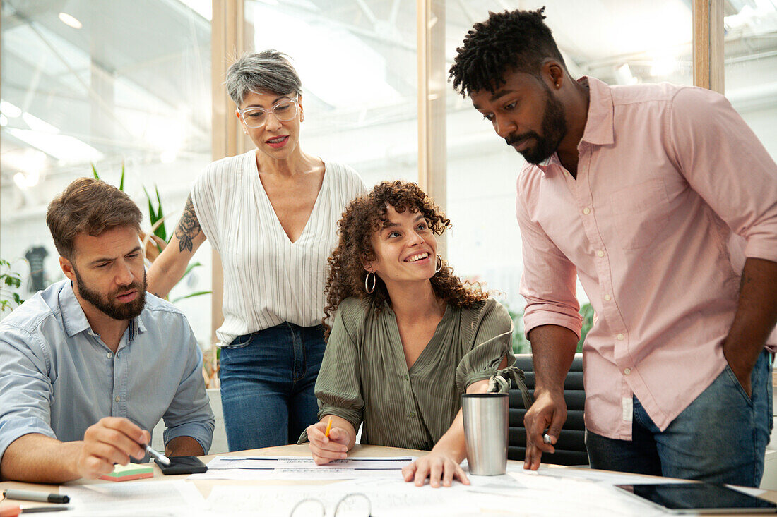 Adult businessman presenting work to coworkers