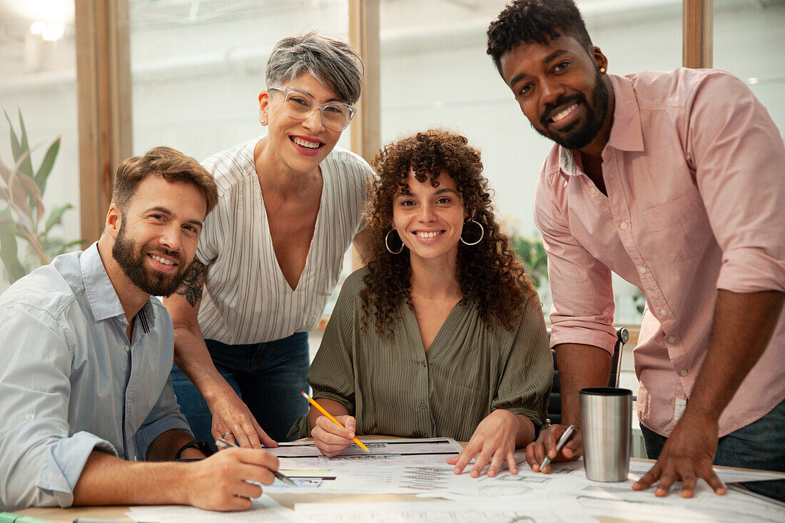 Group of engineers and architects looking at the camera during meeting