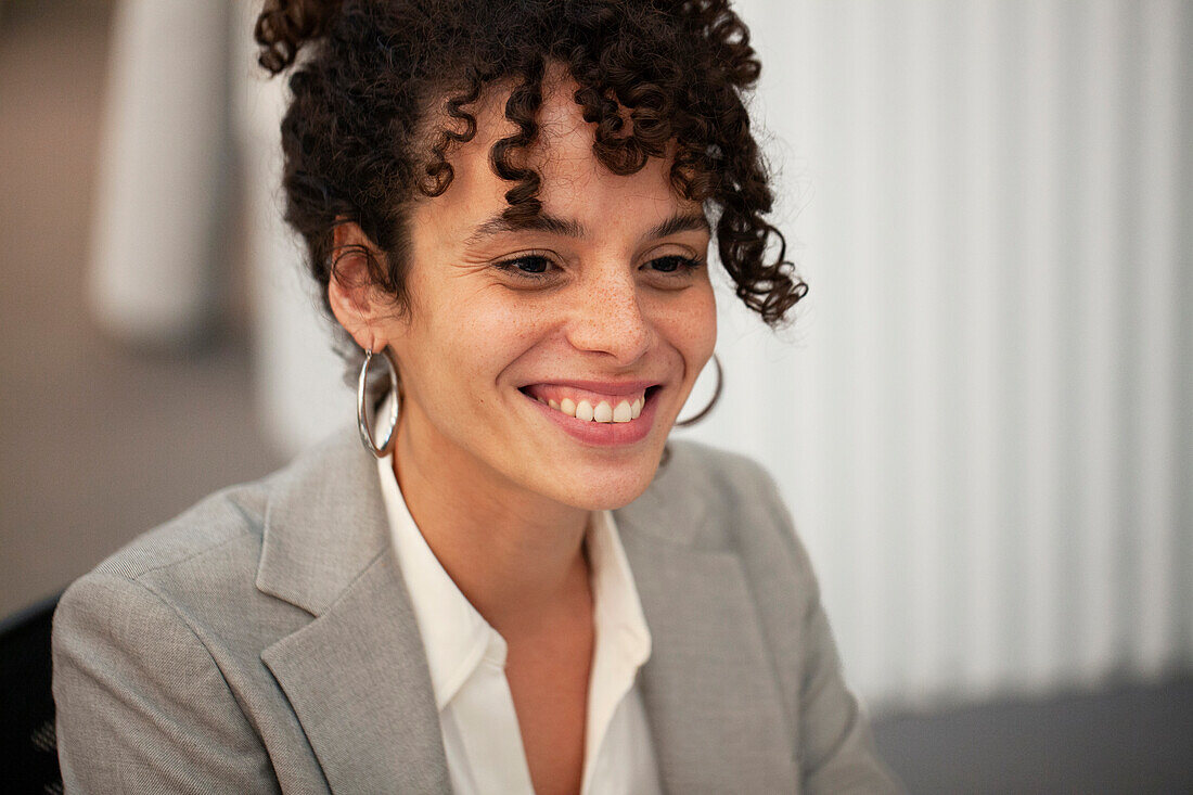 Female bank worker smiling while sitting at office