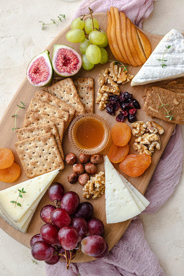 Autumnal cheese platter with fresh pastries and crackers
