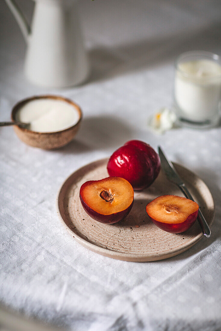 Plums on a ceramic plate on a table