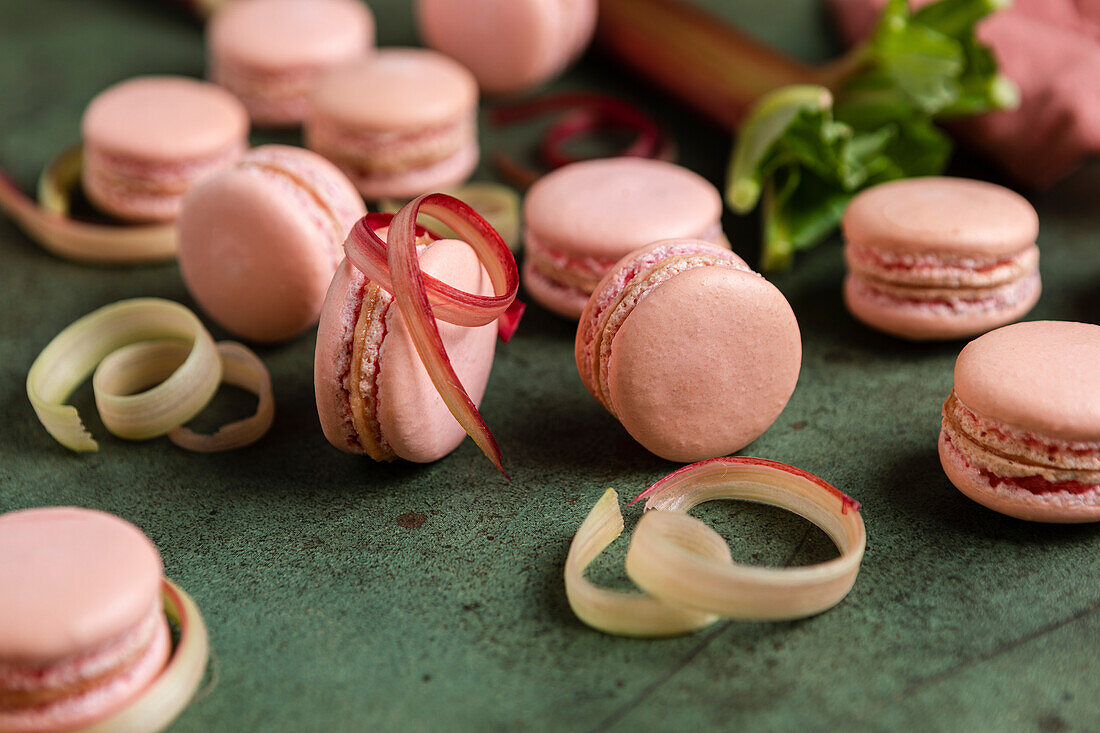 Rhubarb macarons on a green background