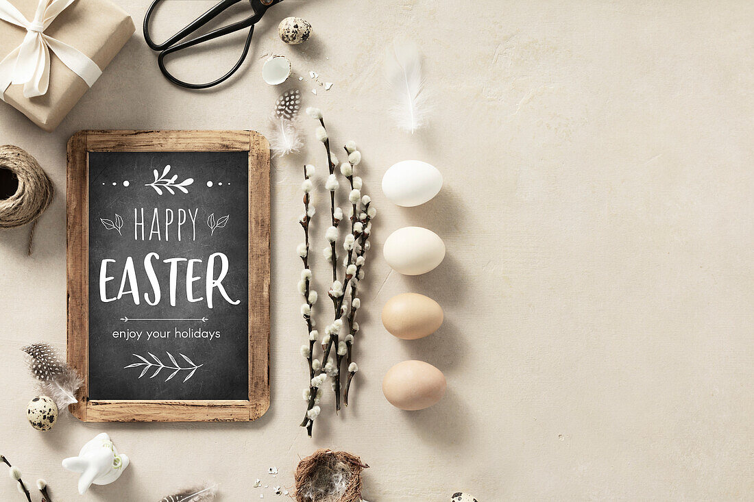 Easter composition with vintage Easter decorations and Happy Easter chalkboard on beige stone background top view flat lay copy space