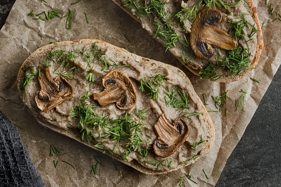 Sandwiches with mushroom pâté and mushrooms on kraft paper