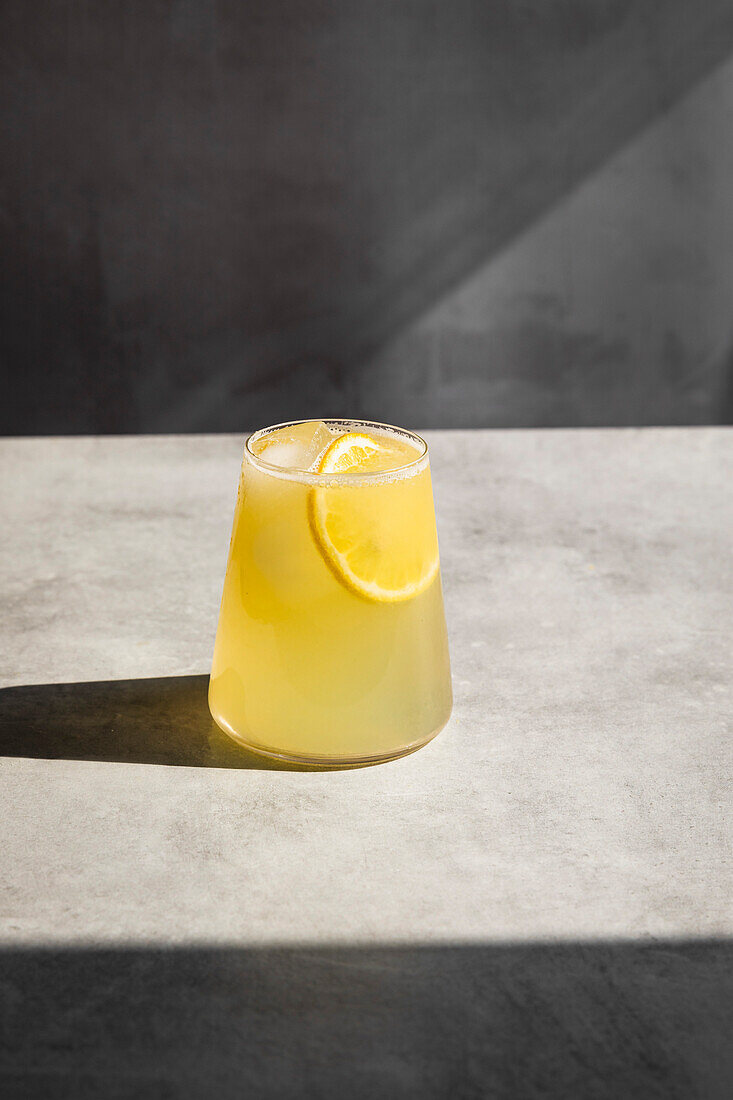 Homemade lemonade with ice and lemon slices in a glass