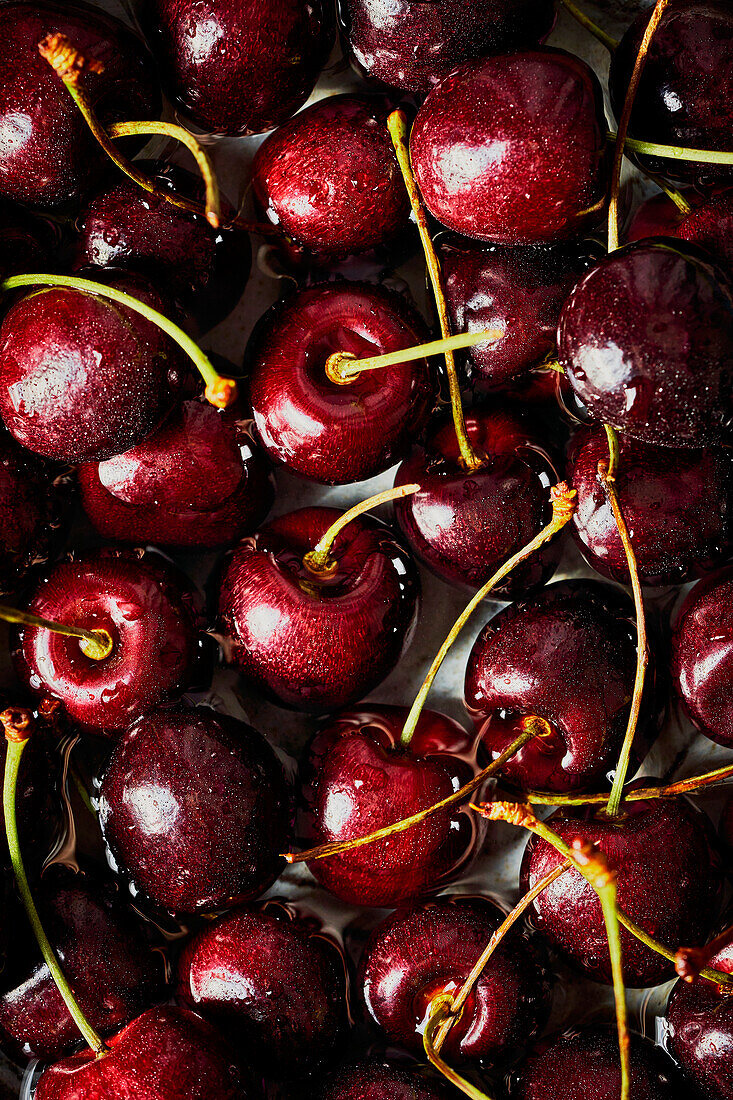 Cherries in a bowl on a dark grey background