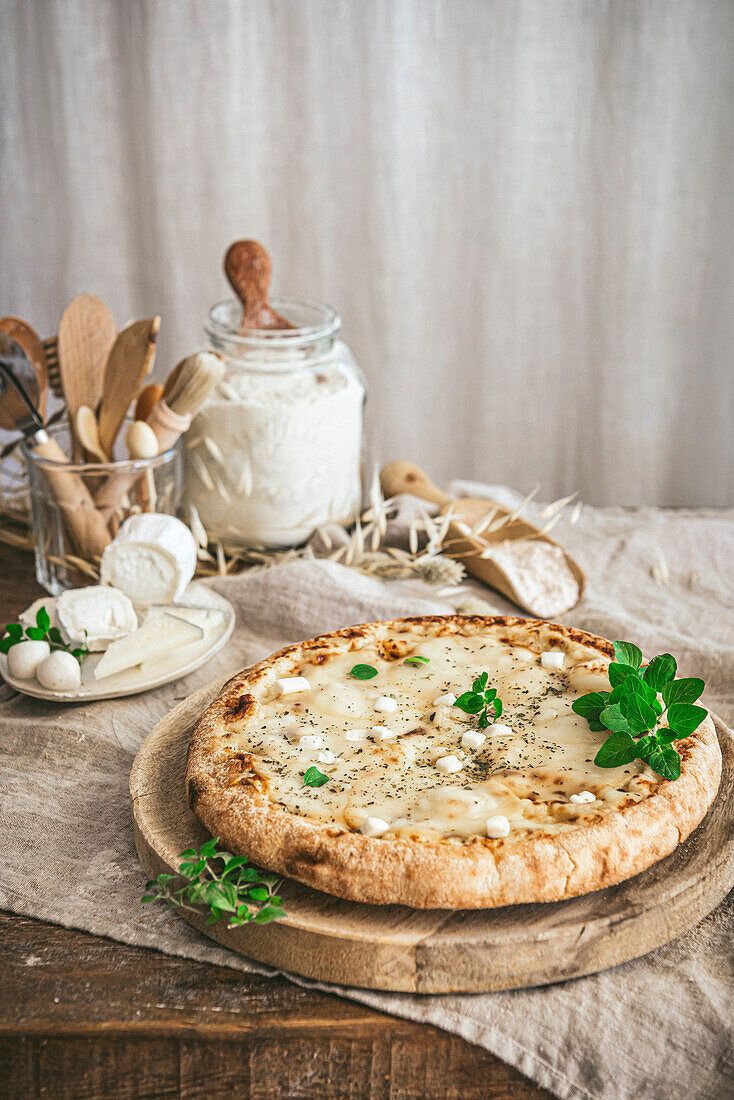 A rustic Carbonara Pizza on a wooden cutting board