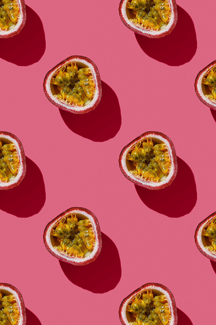 Vertical Pattern of Tropical exotic Passion Fruit on pink background flatlay food