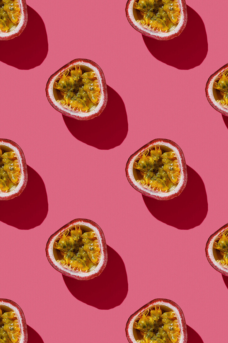 Vertical pattern of tropical exotic passion fruit on pink background flatlay food