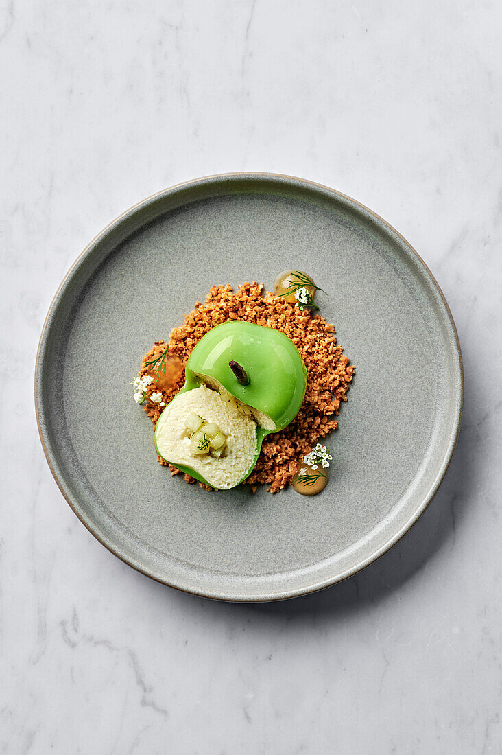 Green apple filled with vanilla bean and white chocolate mousse, apple and dill compote, served with salted oat crumble and apple gel