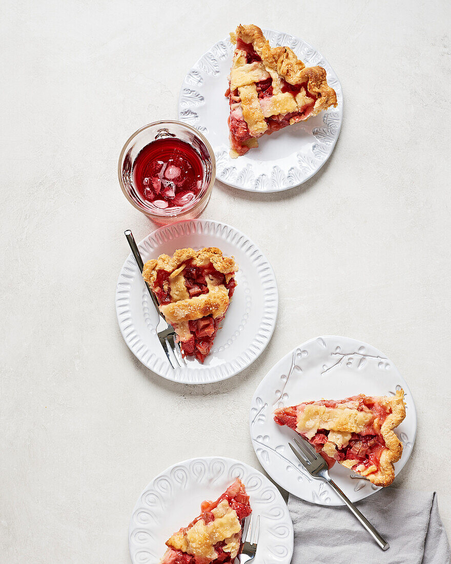 Vegan strawberry and rhubarb cake in slices on a white plate
