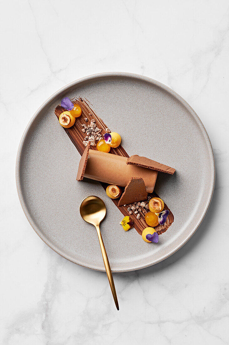 Chocolate mousse, passion fruit quark, candied hazelnuts, cocoa nib praline, passion fruit gel, dried chocolate