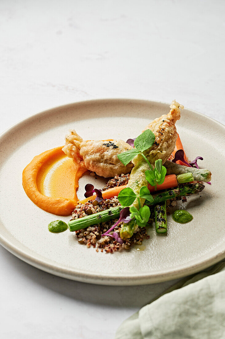 Stuffed courgette flowers, carrot puree, salsa verde, charred asparagus, quinoa and lentils