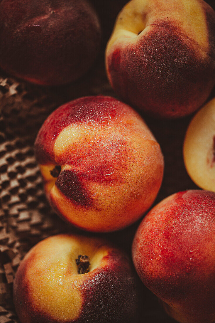 Ripe peaches are prepared on a kitchen table