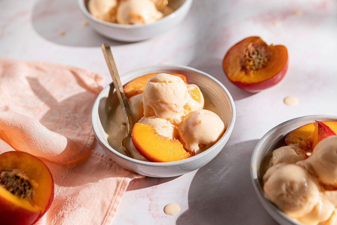 Frozen yoghurt with nectarines in three bowls
