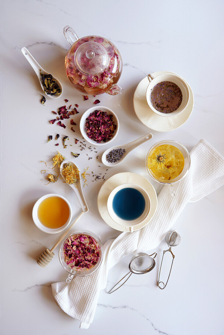 Selection of herbal teas, rose petals, marigolds, lavender and blue butterfly flowers, known for their flavour, medicinal and nutritional properties