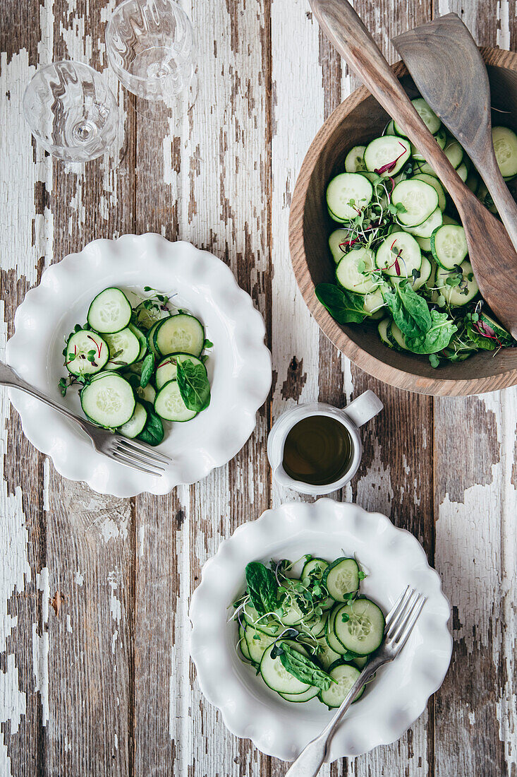 Fresh cucumber salad on a wooden background