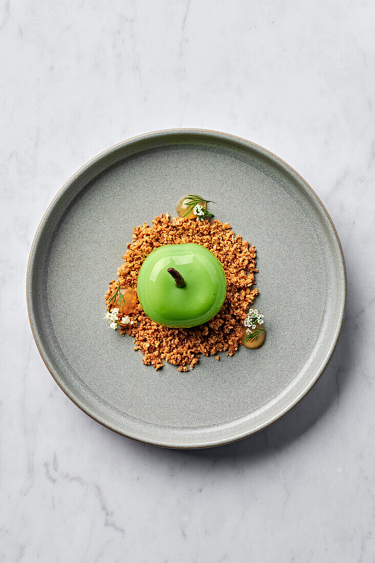Green apple dessert served with salted oat crumble and apple gel