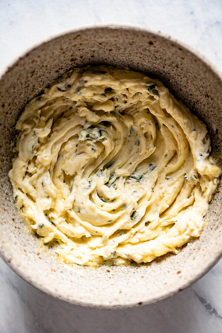 Homemade garlic butter is prepared in a bowl