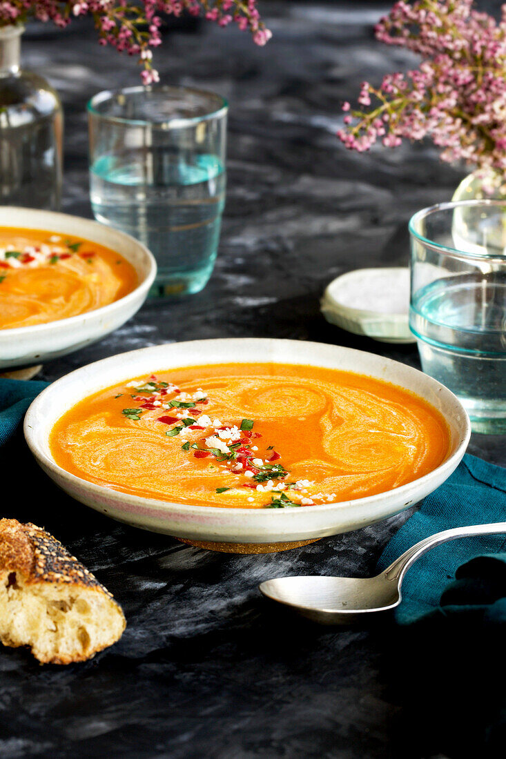 Red Lentil Piquillo Pepper Bisque in white bowls with blue napkins