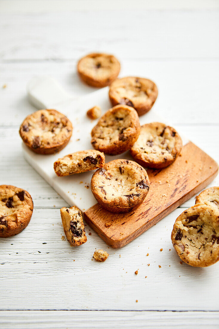 Shortbread biscuits with chocolate chips on a marble board and white background