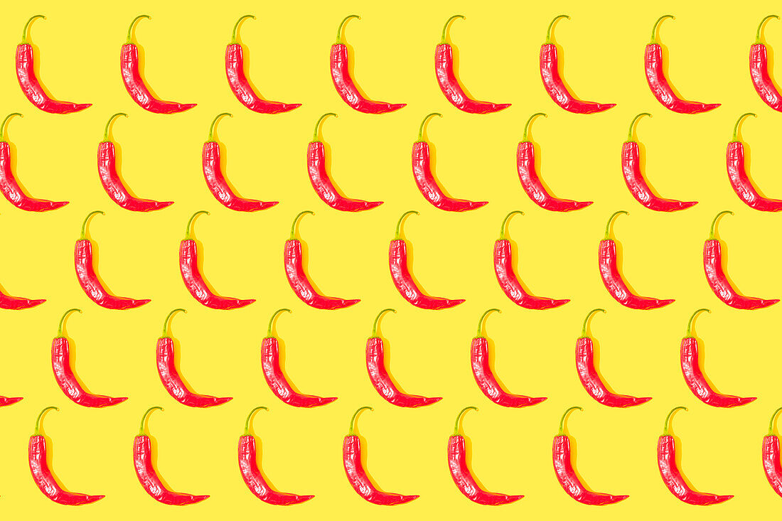 Chilli peppers pattern on yellow background