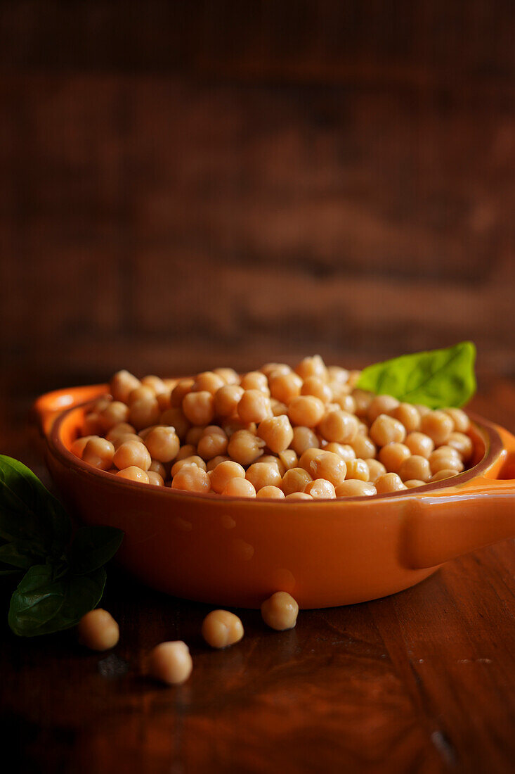 Bowl of cooked high fiber, protein rich legume, garbanzo beans commonly known as chickpeas. Negative copy space.