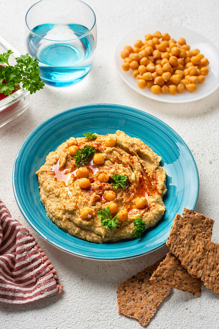 Chickpea hummus and galettes on a blue plate