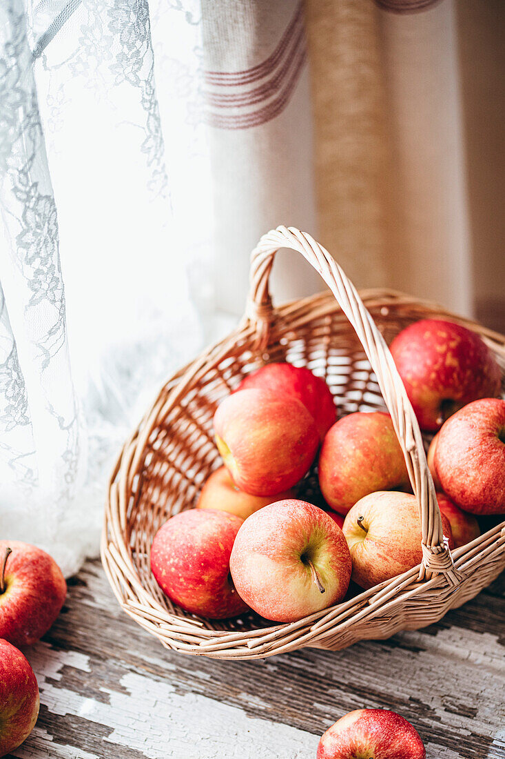 Apples in a basket against a white background