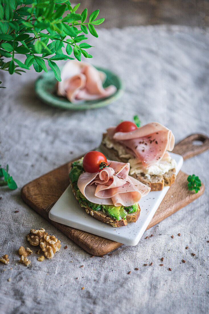 Avocado and ham on toast with tomato