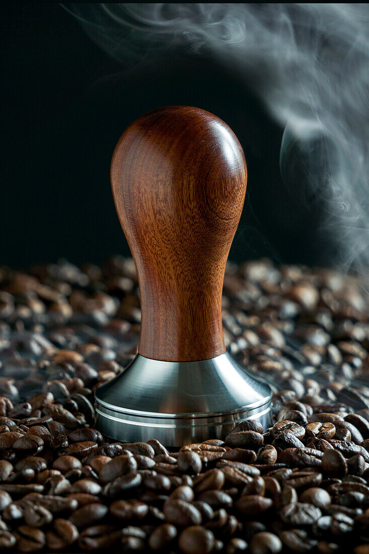 Coffee steamer with steam and coffee beans