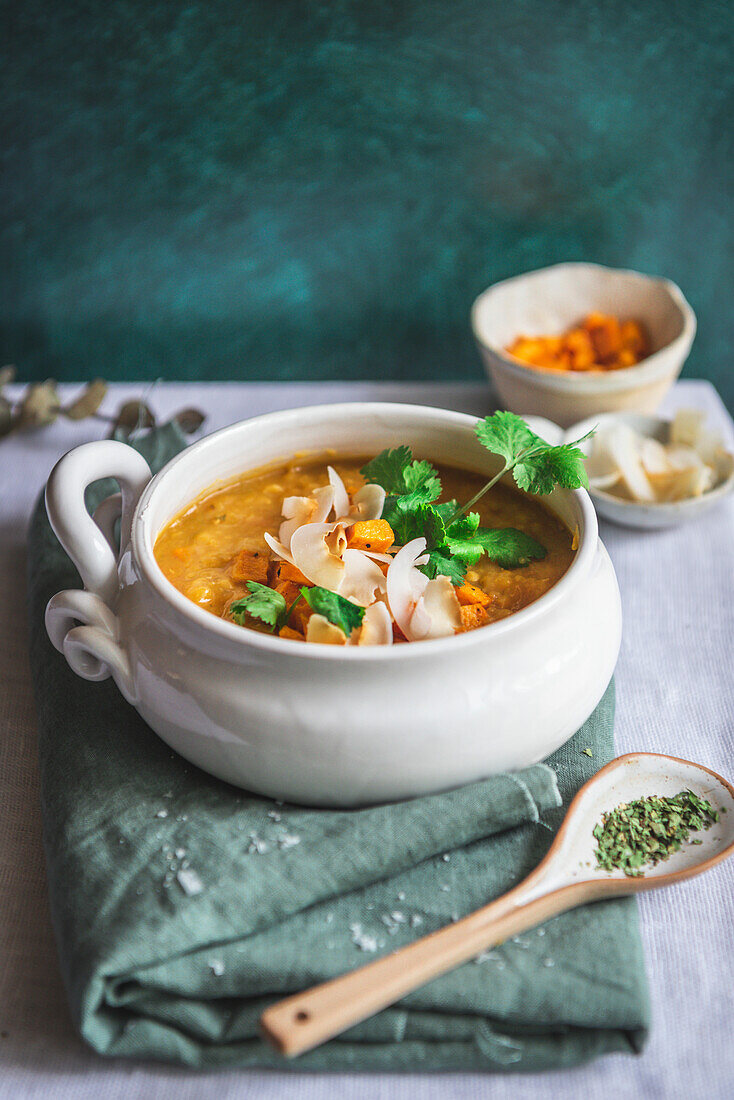 Red lentil and sweet potato soup, served in a white bowl