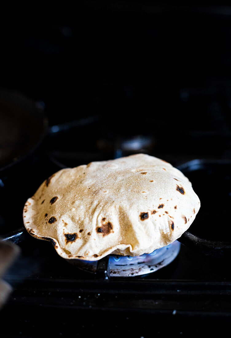 Fresh roti cooking on a flame