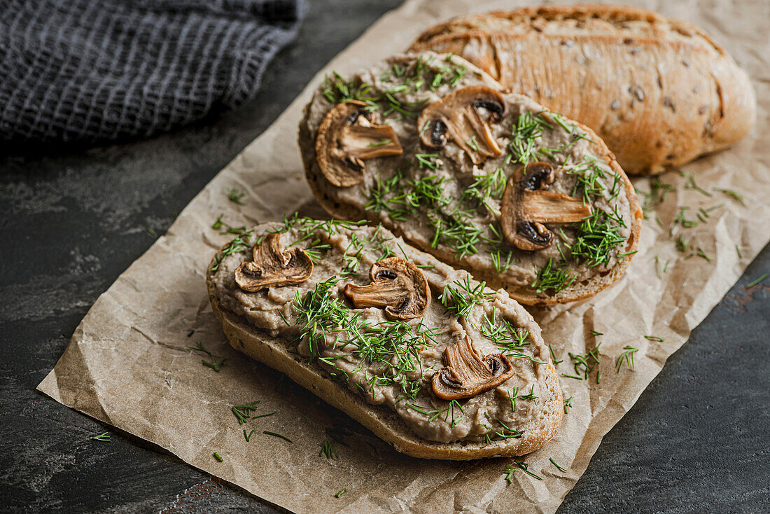 Sandwiches with mushroom pâté and mushrooms on kraft paper