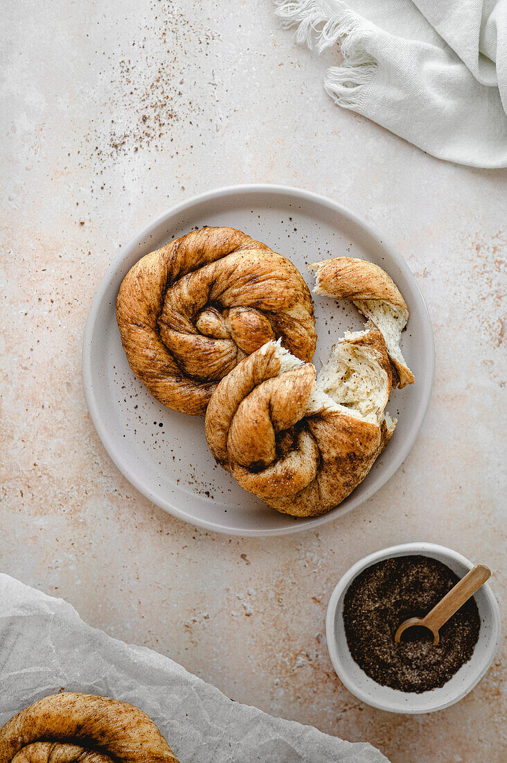 Homemade Dutch cinnamon buns on a plate with brown sugar