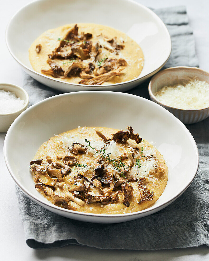 Two bowls of polenta with fried mushrooms