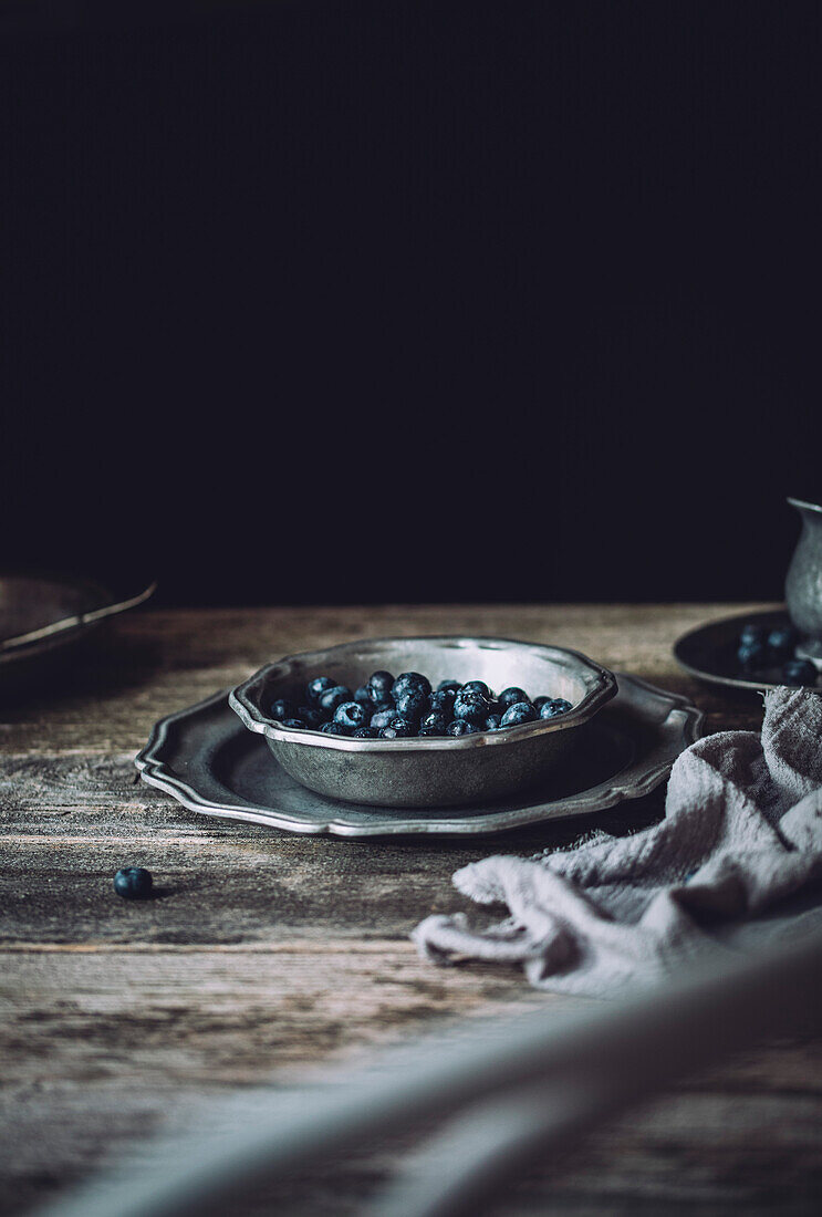 Blueberries in an antique silver bowl